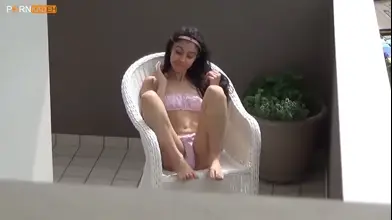 Hidden camera catches petite neighbor girl masturbating on the balcony.